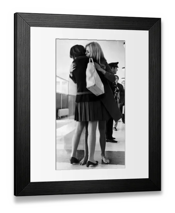 Framed Print : Brigitte Bardot French Actress in London to film Two Weeks embraces her friend Helene