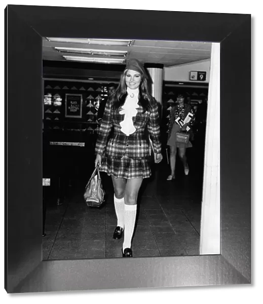 Raquel Welch actress wearing a tartan outfit and long white socks
