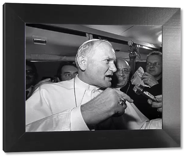 Pope John Paul II is interviewed during a flight on his visit to Ireland