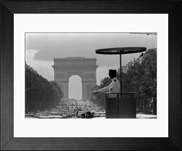 Framed Print : France Paris - a Gendarme officer looks over the traffic at the Arc de Triomphe