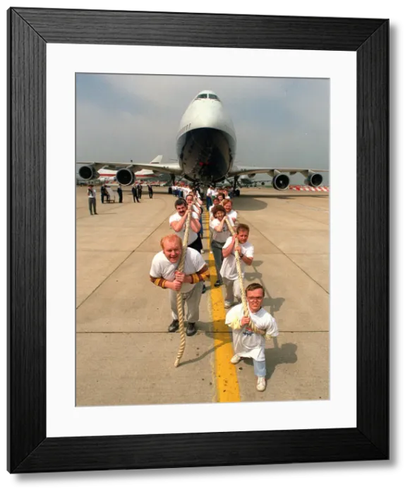 Framed Print : Charity Aircraft Pull. A British Airways Boeing 747 Jumbo Jet is pulled along the tarmac Framed Print : Charity Aircraft Pull. A British Airways Boeing 747 Jumbo Jet is pulled along the tarmac