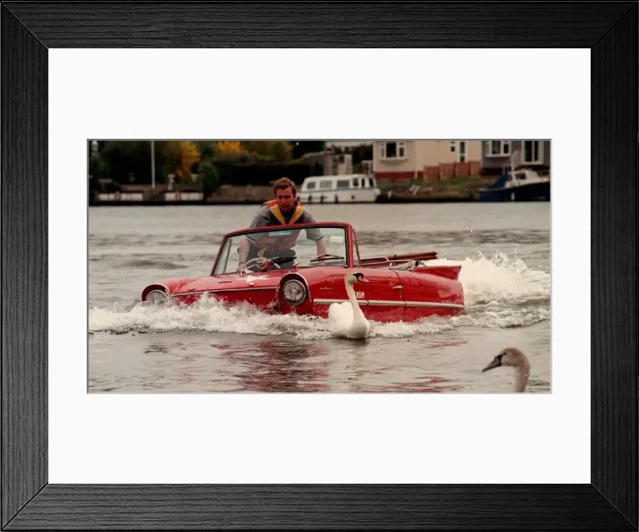 Framed Print : Mark Perkins from Ascot and his 1964 Amphicar March 1998, on the river Thames at Staines