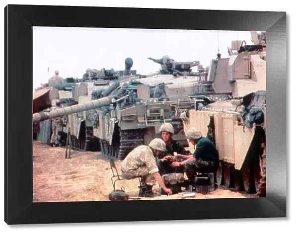 Members of the 7th Armoured Brigade prepare their challenger tanks before the start of