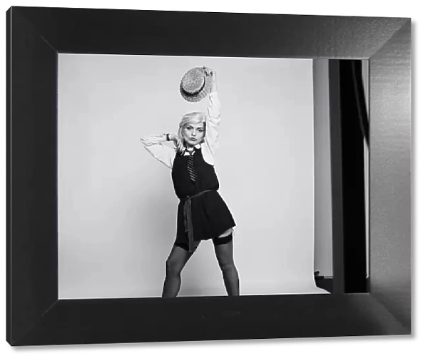 Debbie Harry lead singer of pop group Blondie, poses in the studio wearing school girl