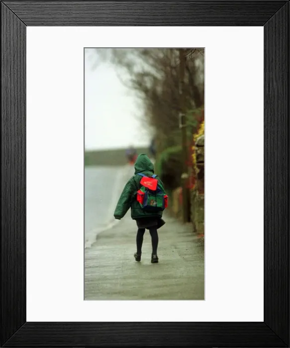 Framed Print : Child heads for lessons at Dunblane Primary School in the morning a year after Framed Print : Child heads for lessons at Dunblane Primary School in the morning a year after