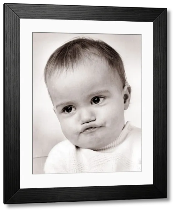 Framed Print : Baby boy with funny face expression, circa 1960 Framed Print : Baby boy with funny face expression, circa 1960