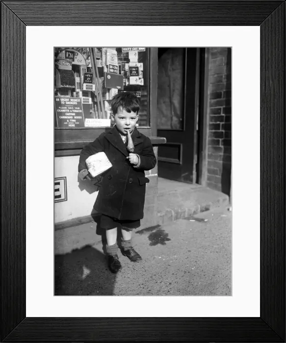 Framed Print : Child eating toffee. Circa 1940 Framed Print : Child eating toffee. Circa 1940