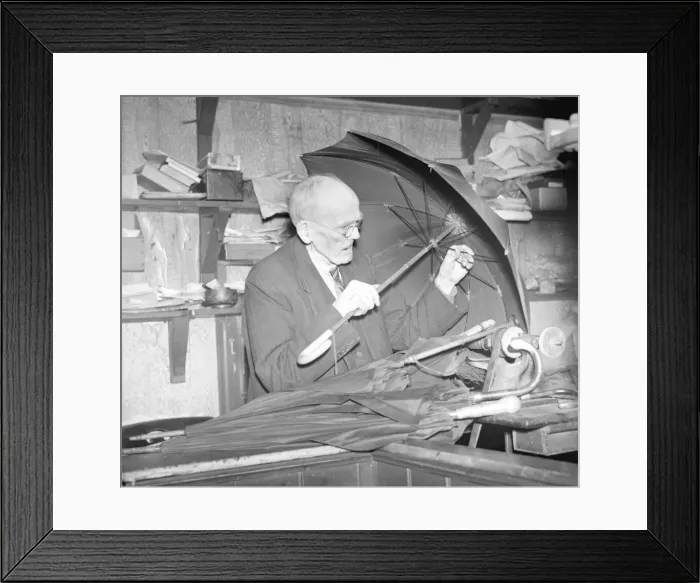 Framed Print : Rev D Smith repairing umbrellas in 1941 Framed Print : Rev D Smith repairing umbrellas in 1941