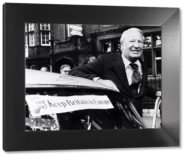 Edward Ted Heath about to get into his car which has a sticker on it saying KEEP BRITAIN