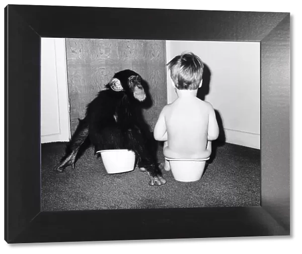 A boy and a monkey doing their business togehter. 1970