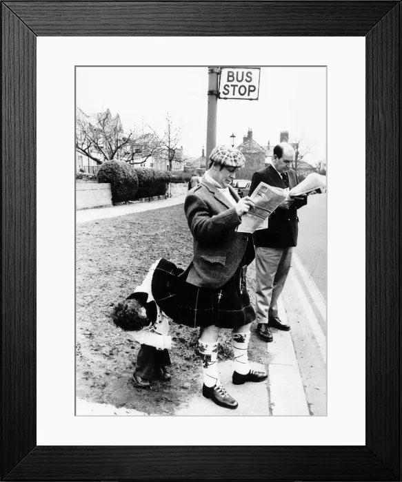 Framed Print : Unusual Picture of young boy satisfying his curiosity by peering under Scotsmans kilt Framed Print : Unusual Picture of young boy satisfying his curiosity by peering under Scotsmans kilt