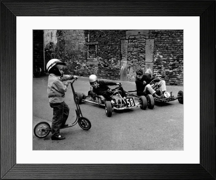 Framed Print : Children play on their scooter and go-karts. Circa 1960 Framed Print : Children play on their scooter and go-karts. Circa 1960