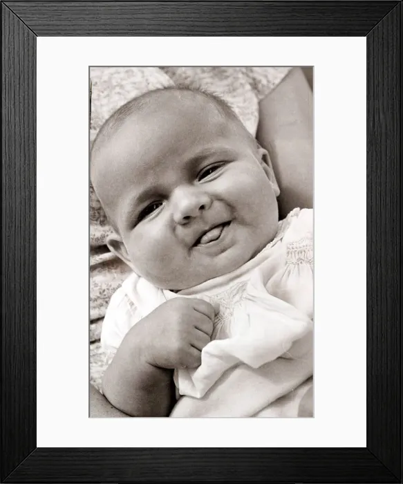 Framed Print : Baby sticking its tongue out, circa 1950