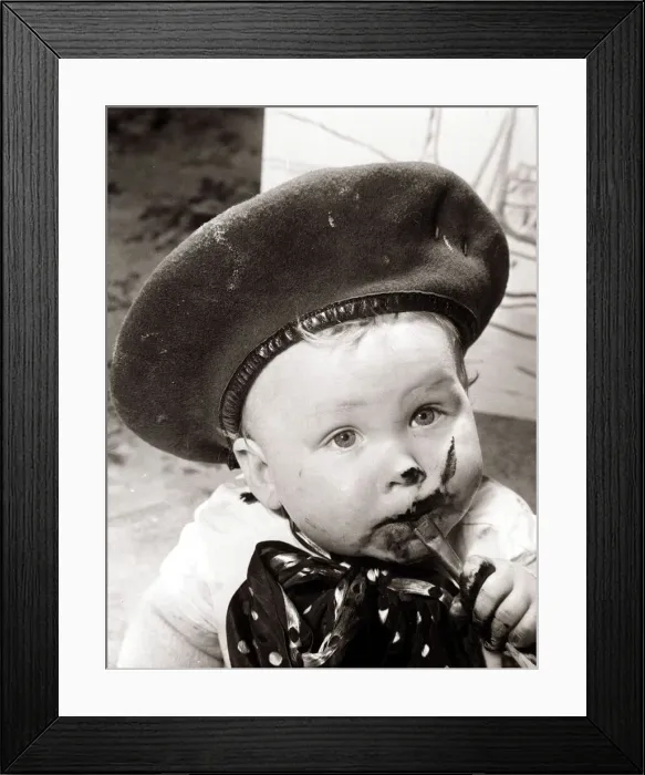 Framed Print : Little boy, eating chocolate in a very messy way. Circa 1950 Framed Print : Little boy, eating chocolate in a very messy way. Circa 1950