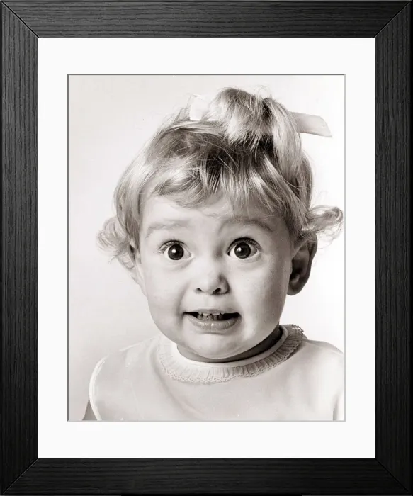 Framed Print : Little girl with her eyes wide open, circa 1970 Framed Print : Little girl with her eyes wide open, circa 1970