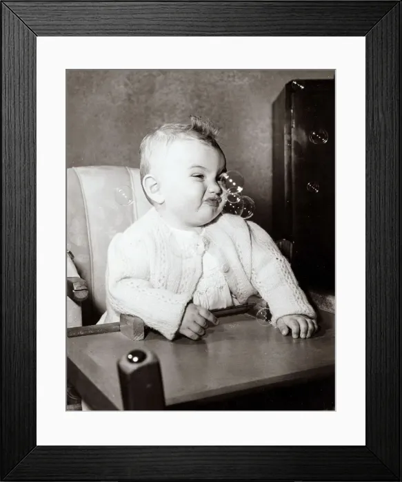 Framed Print : Baby enjoying bubbles in the air, circa 1950 Framed Print : Baby enjoying bubbles in the air, circa 1950