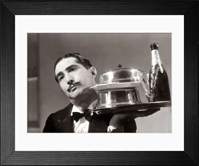 Framed Print : Waiter holding a tray with silverwear and champagne with glass. September 1936 Framed Print : Waiter holding a tray with silverwear and champagne with glass. September 1936