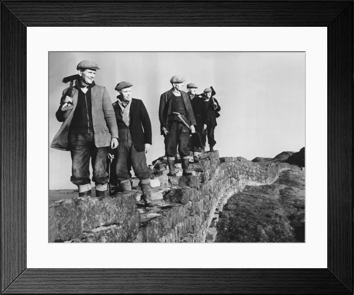 Framed Print : Hadrians Wall - workmen on restoration work pause foor a break as they walk along