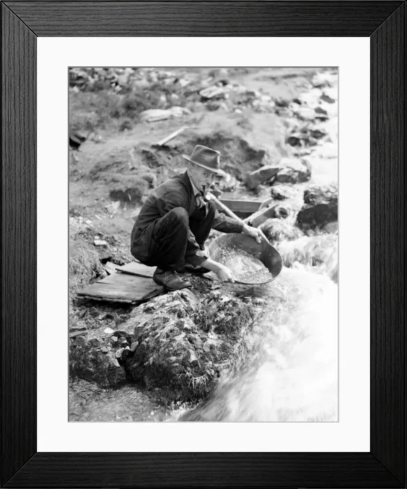 Framed Print : Scottish Gold Prospect, man smoking pipe by a river bank. Circa 1920