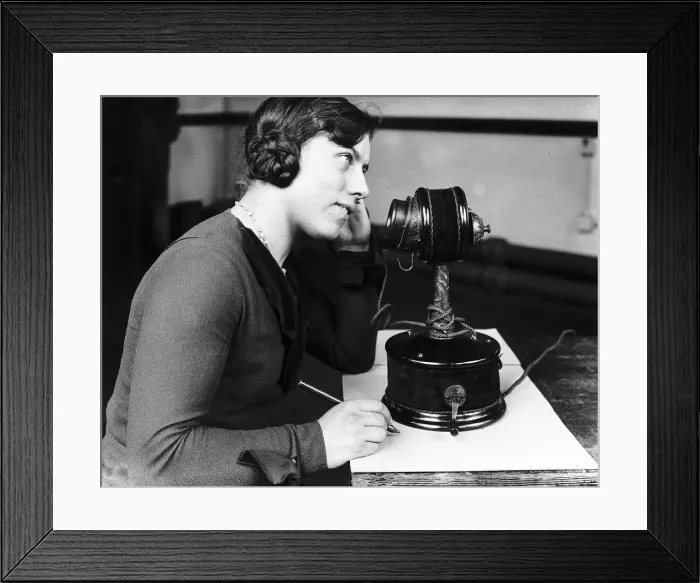 Framed Print : Woman using early telephone. Large candlestick phone Circa 1920 Framed Print : Woman using early telephone. Large candlestick phone Circa 1920