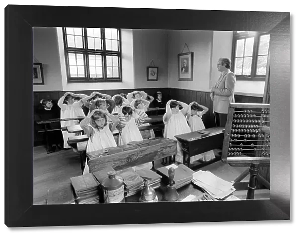 Recreation of an Old fashioned school June 1984, kids withe hands on their heads
