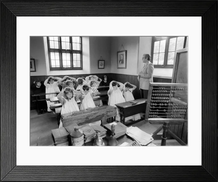 Framed Print : Recreation of an Old fashioned school June 1984, kids withe hands on their heads Framed Print : Recreation of an Old fashioned school June 1984, kids withe hands on their heads