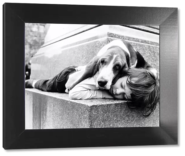 Stephen Durham sleeping with pet Basset hound Sadie. 1972