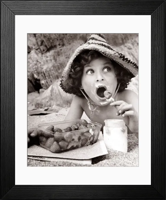 Framed Print : Boy eating strawberries on a beach, circa 1950 Framed Print : Boy eating strawberries on a beach, circa 1950