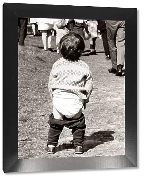 Little child showing off his nappies. Circa 1950