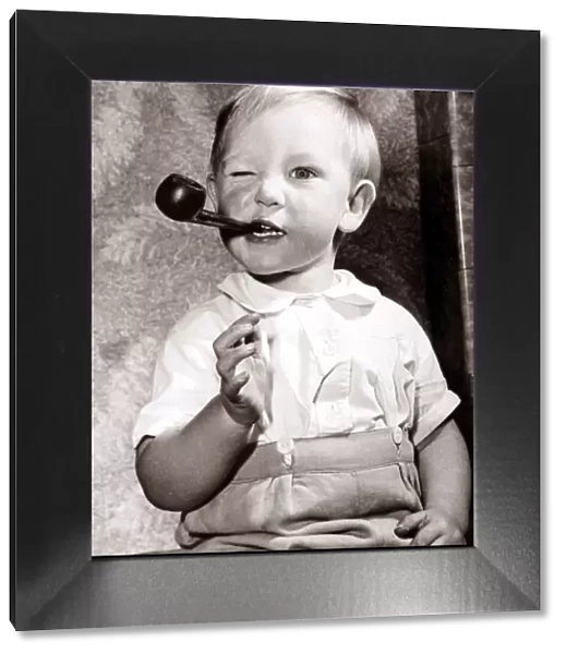 Boy smoking a pipe, circa 1950