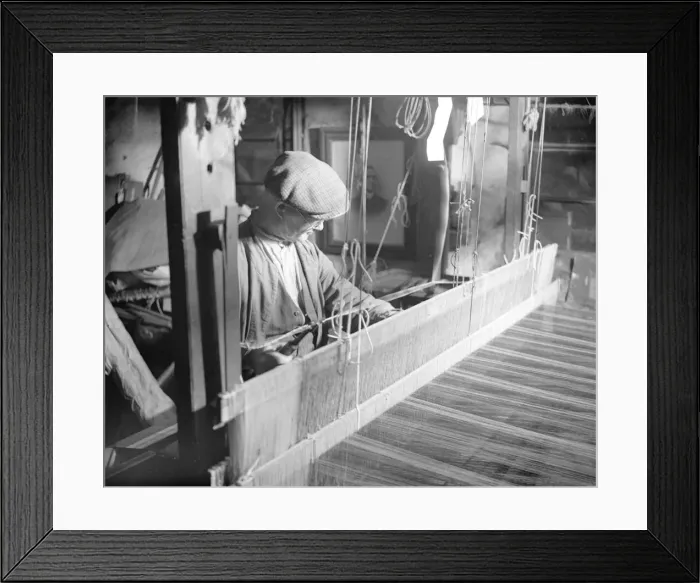 Framed Print : Willie Meisle using a loom to weave a tartan. Circa 1930