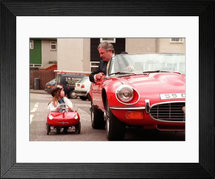 Framed Print : Kerri Duncan in Toy E type Jaguar car April 1998, parked alongside Graeme Moyes principal