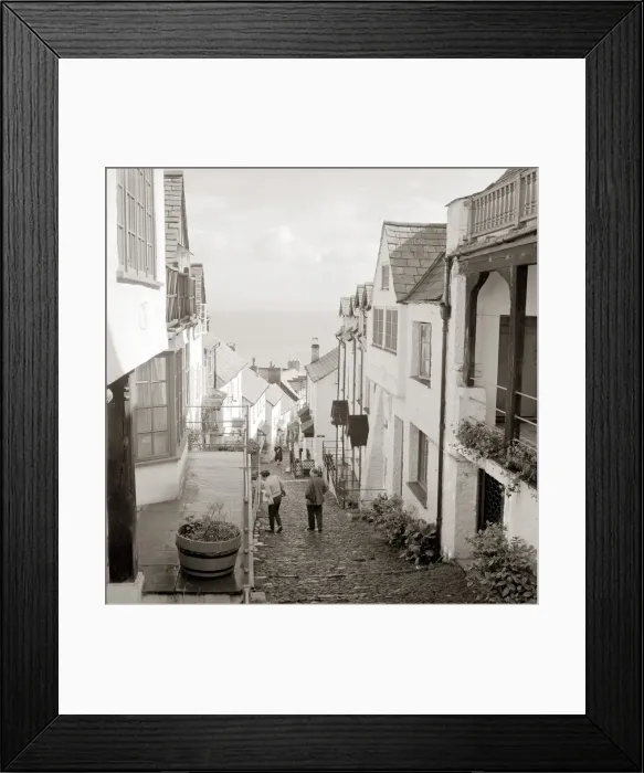 Framed Print : Tourists making their way down the steep hill in the village of Clovelly in North Devon Framed Print : Tourists making their way down the steep hill in the village of Clovelly in North Devon