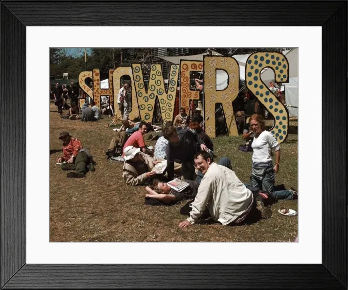 Framed Print : The showers at the Glastonbury Festival 1999 as fans relax in the sunshine