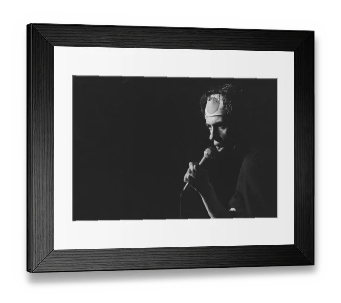 Framed Print : Bob Geldof of the Boomtown Rats pop group, pictured wearing a headband during a concert
