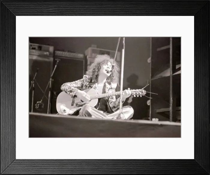Framed Print : Marc Bolan in concert at th Empire Pool, Wembley. Sitting on stage cross legged