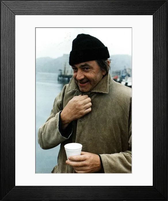 Framed Print : Bill Forsyth film director collar of coat turned up woollen hat paper cup on quayside