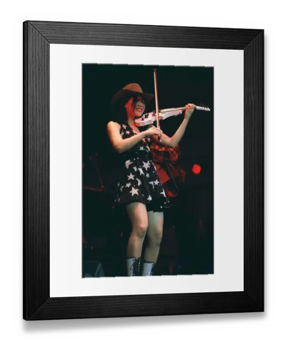 Framed Print : Vanessa Mae on stage playing white violin wearing mini skirt