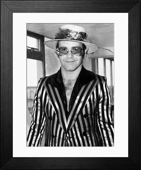Framed Print : Elton John Pop singer pases through Heathrow Airport on his way back from Los Angeles