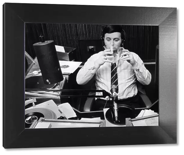 Terry Wogan drinking a jug of water during his record programme on Radio One