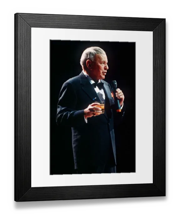 Framed Print : Frank Sinatra sings in concert with drink in hand