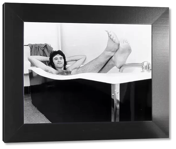 David Essex singer actor relaxes in a hot bath while on a hectic 52 date tour 1976