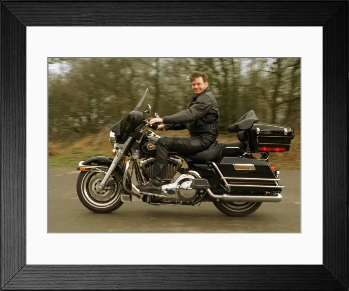 Framed Print : John Gordon Sinclair polishing his Harley Davidson Electra Glide motorbike March 1997