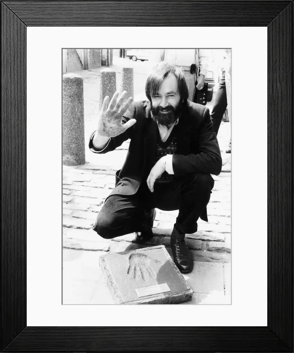 Framed Print : Bill Forsyth film producer making hand impression hand print in paving stone outside Framed Print : Bill Forsyth film producer making hand impression hand print in paving stone outside