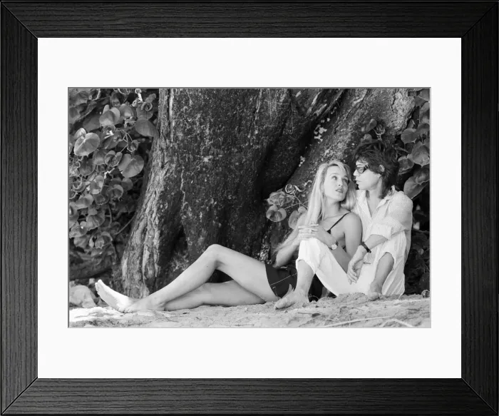 Framed Print : Rolling Stones: Jerry Hall and Mick Jagger sit on a Barbados beach. February 1987 Framed Print : Rolling Stones: Jerry Hall and Mick Jagger sit on a Barbados beach. February 1987