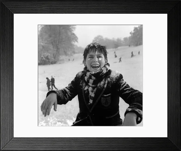 Framed Print : A small boy playing in the snow on Hampstead Heath, New Years Day 1962 Framed Print : A small boy playing in the snow on Hampstead Heath, New Years Day 1962