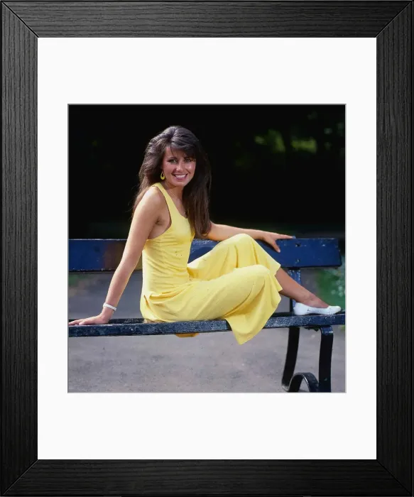 Framed Print : Debbie Greenwood TV presenter July 1987 sitting o a bench wearing a yellow dress Framed Print : Debbie Greenwood TV presenter July 1987 sitting o a bench wearing a yellow dress
