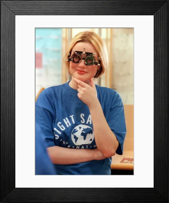 Framed Print : BBC TV Presenter Kate Heavner October 1999 About to test her eye sight at Boots