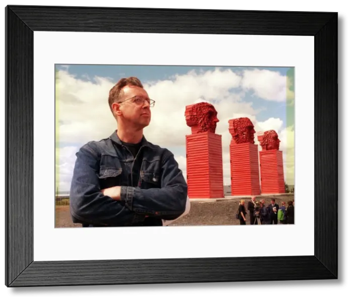 Framed Print : Sculptor David Mach June 1999 beside his Big Heids sculpture alongside the A8