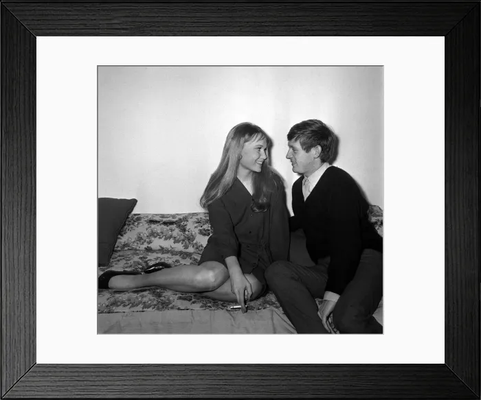 Framed Print : Actress Mia Farrow with singer John Leyton April 1964 sitting on sofa talking Framed Print : Actress Mia Farrow with singer John Leyton April 1964 sitting on sofa talking